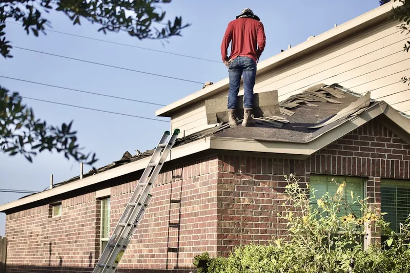 Professional roofer working on a residential roof in North Palm Springs